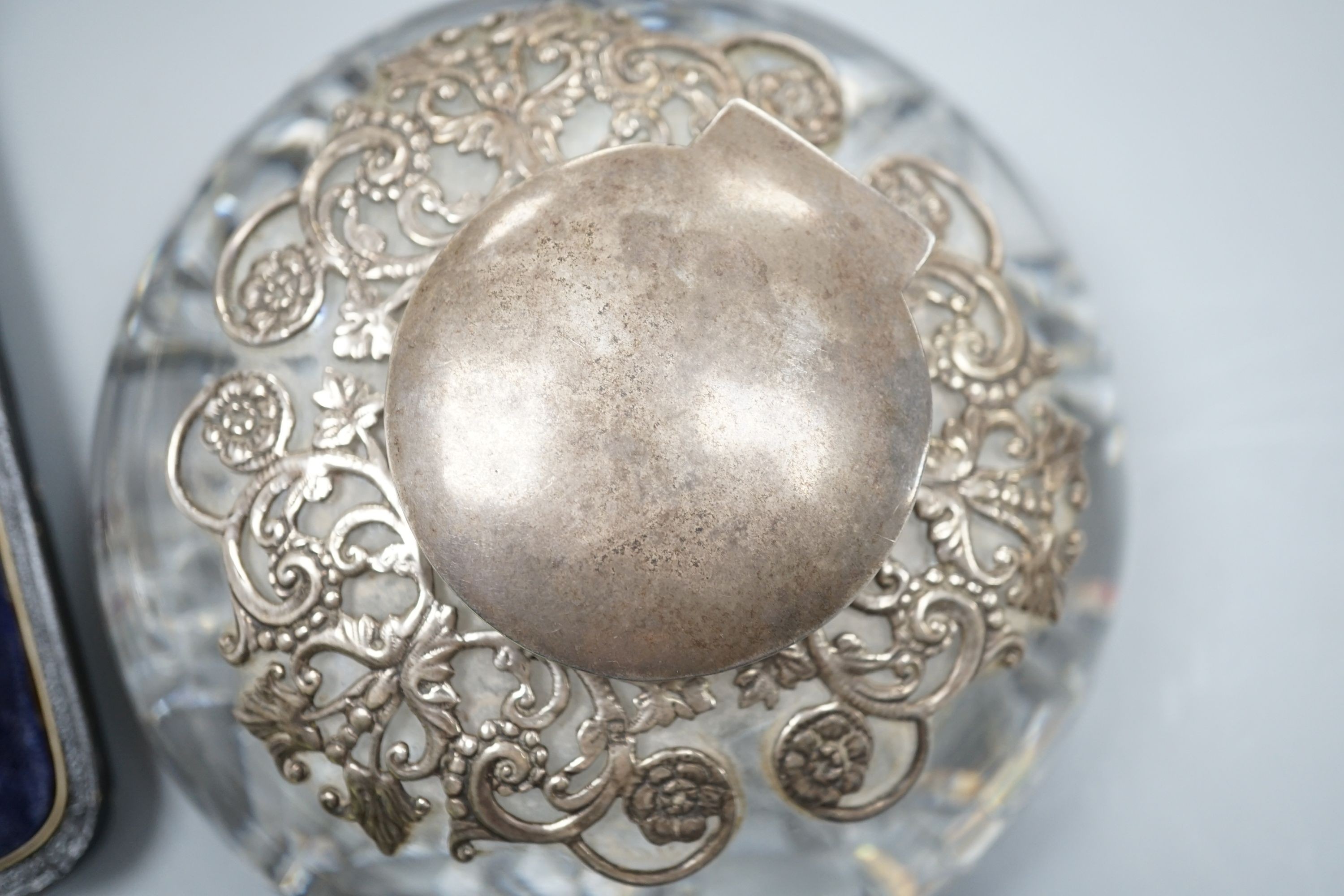 A glass silver mounted inkwell, 2 napkin rings boxed silver dishes and an enamel box